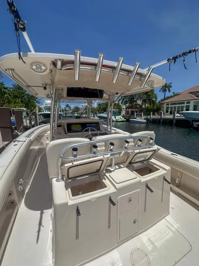  Yacht Photos Pics 2010 Grady-White Canyon 336 boat docked, featuring spacious deck and fishing rod holders.