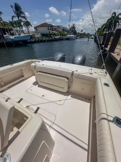  Yacht Photos Pics 2010 Grady-White Canyon 336 boat docked in a sunny canal setting.