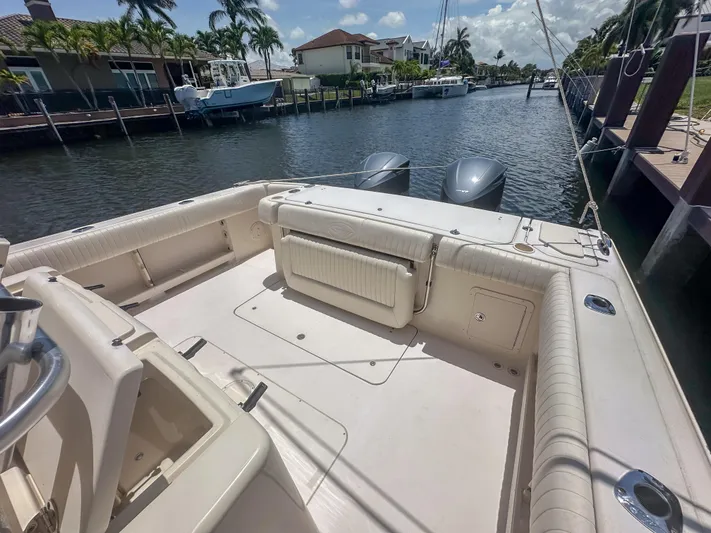  Yacht Photos Pics 2010 Grady-White Canyon 336 boat docked in a scenic canal setting.