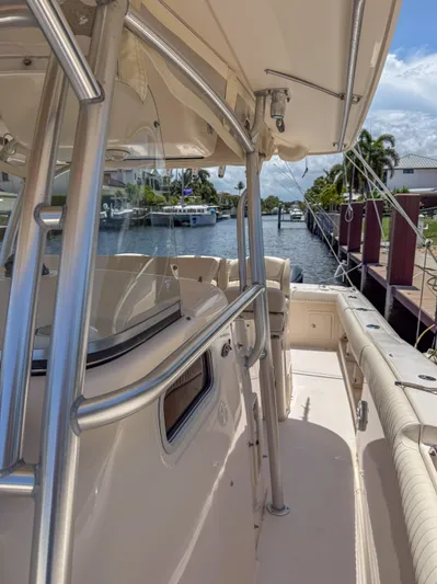  Yacht Photos Pics 2010 Grady-White Canyon 336 boat docked by a scenic waterfront.
