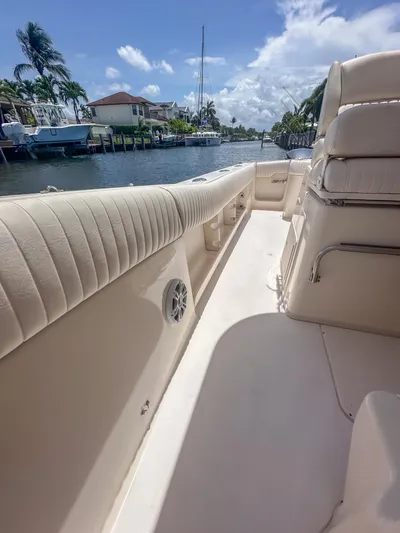  Yacht Photos Pics 2010 Grady-White Canyon 336 boat interior with plush seating, docked by a scenic canal.