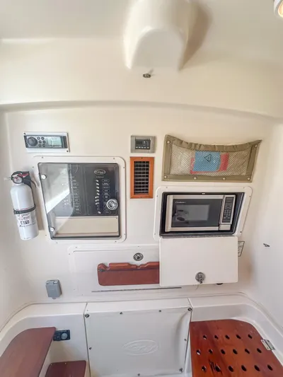  Yacht Photos Pics Interior of 2010 Grady-White Canyon 336 boat with microwave and control panel.
