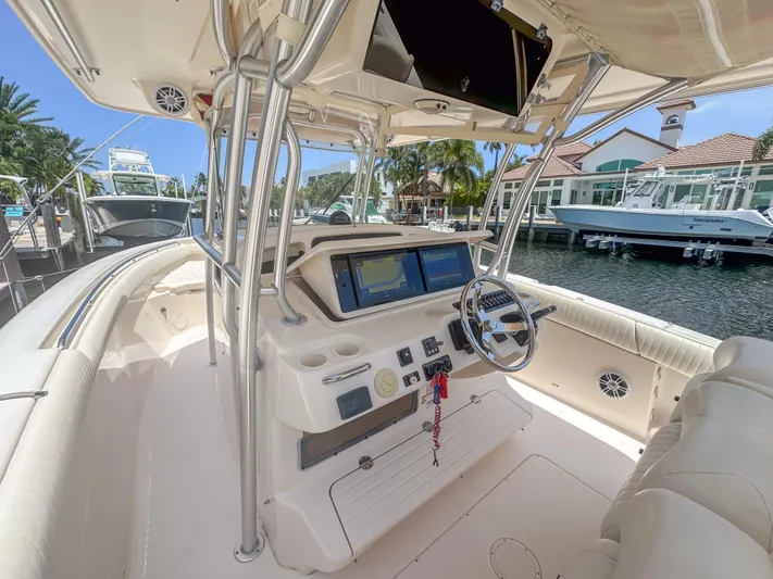  Yacht Photos Pics 2010 Grady-White Canyon 336 boat interior with modern navigation system and steering wheel.