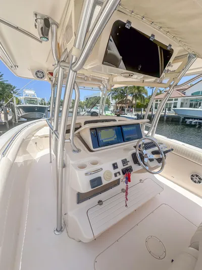  Yacht Photos Pics 2010 Grady-White Canyon 336 boat cockpit with dual screens and steering wheel.