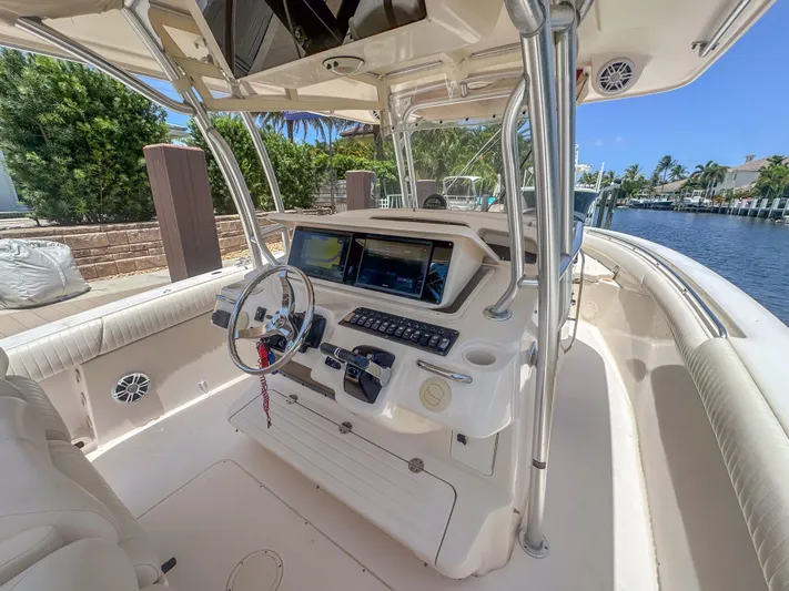  Yacht Photos Pics 2010 Grady-White Canyon 336 boat cockpit with steering wheel and navigation screens.