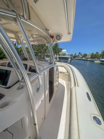  Yacht Photos Pics 2010 Grady-White Canyon 336 boat docked by a scenic waterfront.