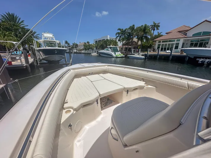  Yacht Photos Pics 2010 Grady-White Canyon 336 boat docked in sunny marina with palm trees.