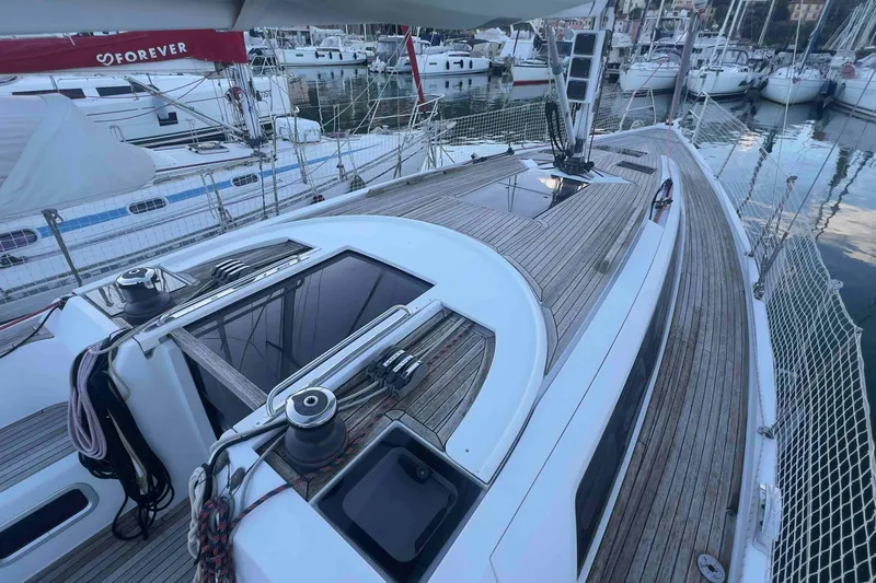 Yacht Photos Pics 2015 Grand Soleil 39 Maletto sailboat with sleek wooden deck in marina setting.