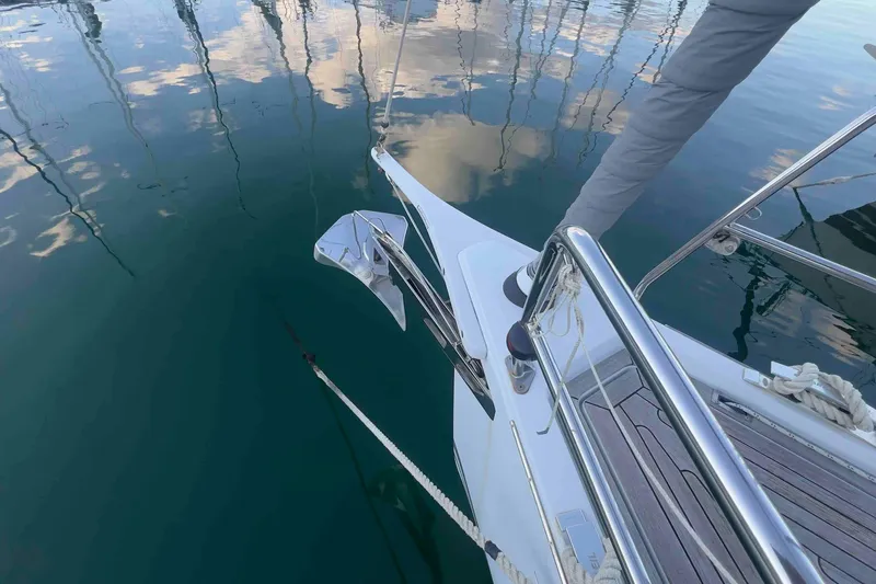  Yacht Photos Pics Grand Soleil 39 Maletto 2015 yacht bow with anchor, reflecting on calm water.