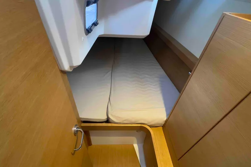  Yacht Photos Pics Cabin interior of 2015 Grand Soleil 39 Maletto yacht with wooden finish and cozy bed.