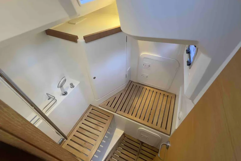  Yacht Photos Pics Interior of 2015 Grand Soleil 39 Maletto yacht, featuring wooden flooring and modern shower area.