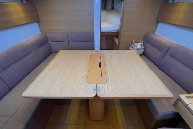  Yacht Photos Pics Interior of 2015 Grand Soleil 39 Maletto yacht with cozy seating and wooden table.