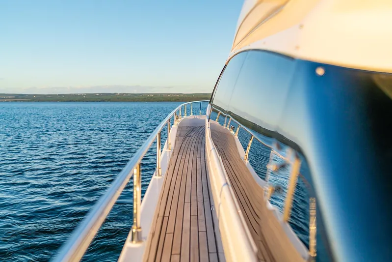 M/y La Seduction Yacht Photos Pics 2022 Ferretti Yachts 550 cruising on serene blue waters at sunset.