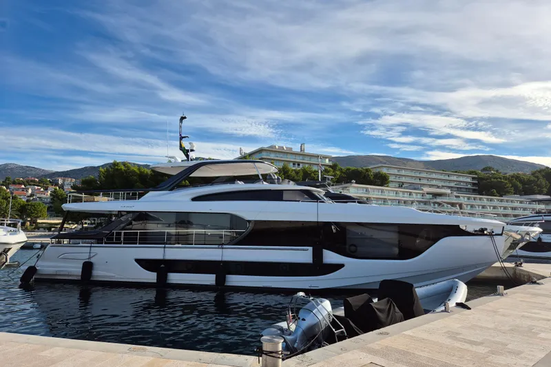  Yacht Photos Pics 2025 Azimut Grande 26M luxury yacht docked at a marina with scenic background.
