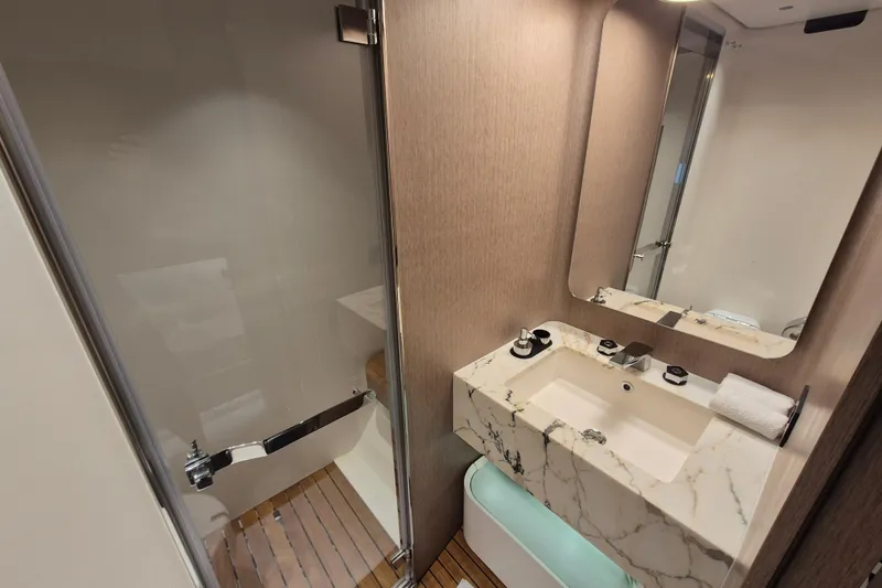  Yacht Photos Pics Luxurious bathroom in 2025 Azimut Grande 26M yacht with marble sink and modern shower.