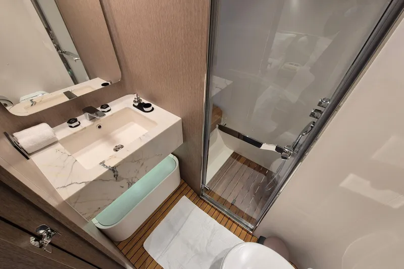  Yacht Photos Pics Luxurious bathroom in 2025 Azimut Grande 26M yacht with marble sink and glass shower.