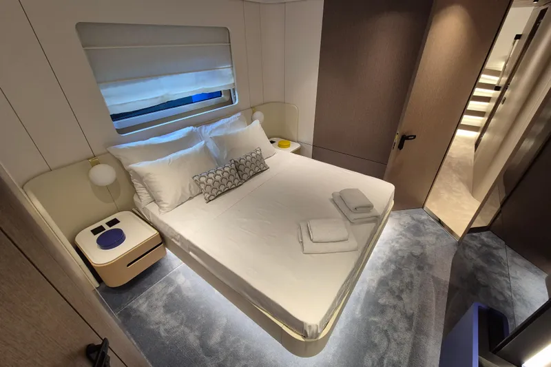  Yacht Photos Pics Luxurious bedroom interior of 2025 Azimut Grande 26M yacht with modern design and cozy ambiance.
