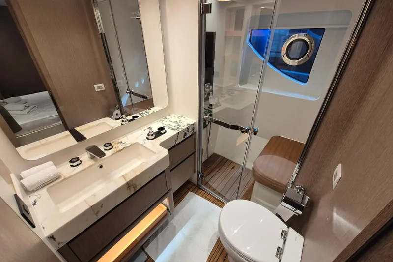  Yacht Photos Pics Luxurious bathroom in 2025 Azimut Grande 26M yacht, featuring elegant marble and modern fixtures.