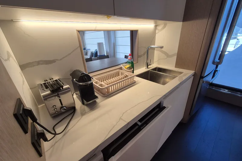  Yacht Photos Pics Modern kitchen in 2025 Azimut Grande 26M yacht with sleek appliances and marble countertop.