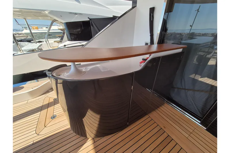  Yacht Photos Pics Luxury deck bar on 2025 Azimut Grande 26M yacht with sleek design and wooden accents.