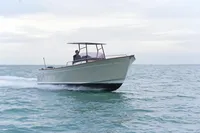 2026 Rhea 27 Open V2 boat cruising on calm sea waters.