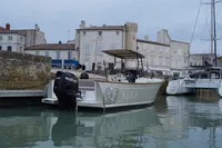 Rhea 27 Open V2 boat docked in a historic harbor, 2026 model.