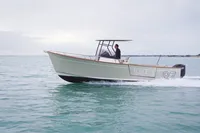 2026 Rhea 27 Open V2 boat cruising on calm waters.