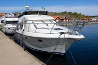 Storebro 435 Commander 2010 yacht docked at a marina with scenic background.