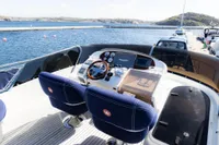 Storebro 435 Commander 2010 yacht helm with dual seats, docked by scenic waters.