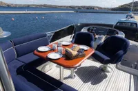 Luxurious 2010 Storebro 435 Commander yacht deck with dining setup, overlooking serene waters.