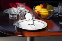 Elegant table setting on Storebro 435 Commander yacht, featuring fruit bowl and glassware.