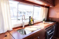 Luxurious kitchen interior of 2010 Storebro 435 Commander yacht with window view.