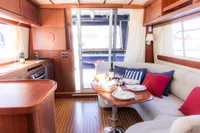 Luxurious interior of 2010 Storebro 435 Commander yacht with elegant dining setup.