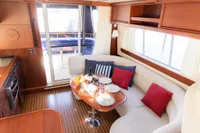 Luxurious interior of 2010 Storebro 435 Commander yacht with elegant dining setup.
