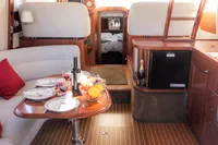 Luxurious interior of 2010 Storebro 435 Commander yacht with elegant dining setup.
