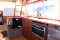 Luxurious interior of 2010 Storebro 435 Commander yacht with modern kitchen amenities.
