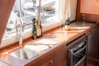 Luxurious 2010 Storebro 435 Commander yacht kitchen with wood finish and modern appliances.