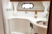 Luxurious bathroom in 2010 Storebro 435 Commander yacht with modern fixtures and elegant wood accents.