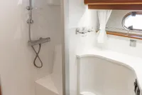 Luxurious bathroom in 2010 Storebro 435 Commander yacht with shower and toilet.