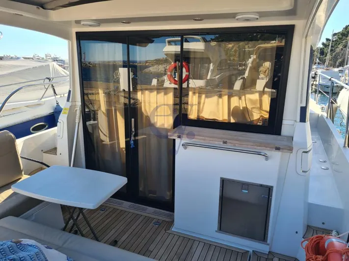 P Yacht Photos Pics 2018 Sealine C330 yacht with sliding glass doors and outdoor seating area.