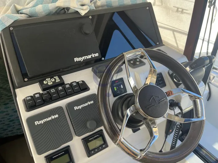 P Yacht Photos Pics 2018 Sealine C330 yacht dashboard with Raymarine navigation equipment and steering wheel.