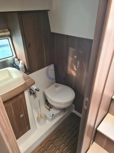 P Yacht Photos Pics 2018 Sealine C330 yacht bathroom with wooden accents and compact design.