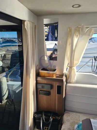 P Yacht Photos Pics Interior of 2018 Sealine C330 yacht with elegant wood paneling and large windows.
