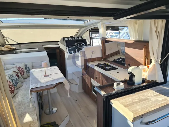 P Yacht Photos Pics Interior of 2018 Sealine C330 yacht with modern kitchen and seating area.
