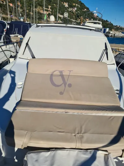 P Yacht Photos Pics 2018 Sealine C330 yacht with beige seating, docked in a marina under clear skies.