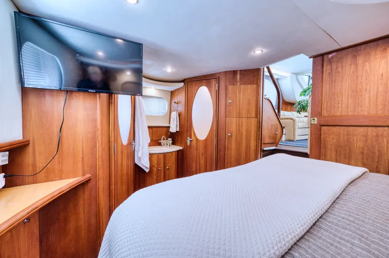 Turn The Paige Yacht Photos Pics Interior of 2003 Silverton 43 Motor Yacht with TV and wood furnishings.