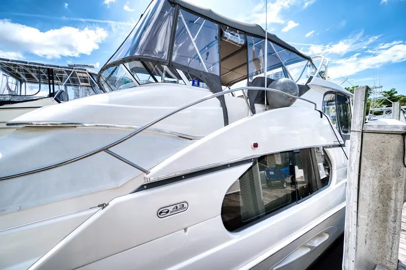Turn The Paige Yacht Photos Pics 2003 Silverton 43 Motor Yacht docked under sunny skies.