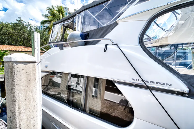 Turn The Paige Yacht Photos Pics 2003 Silverton 43 Motor Yacht docked, side view.