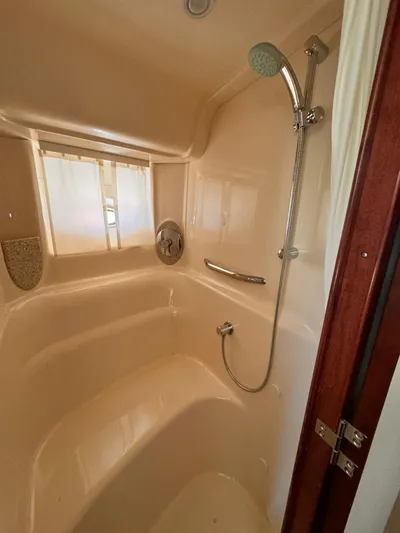 The Boardroom Yacht Photos Pics Shower area inside a 2008 Sea Ray Sundancer boat, featuring a handheld showerhead.