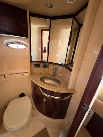 The Boardroom Yacht Photos Pics Luxurious 2008 Sea Ray Sundancer bathroom with sink, toilet, and mirrored cabinets.